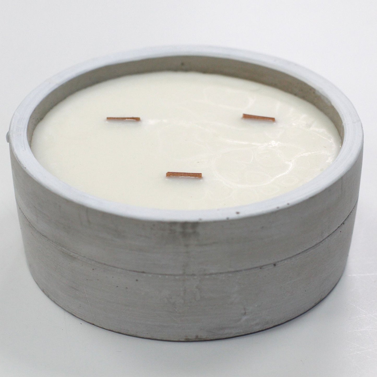 Large round concrete candle with warm patchouli amber fragrance