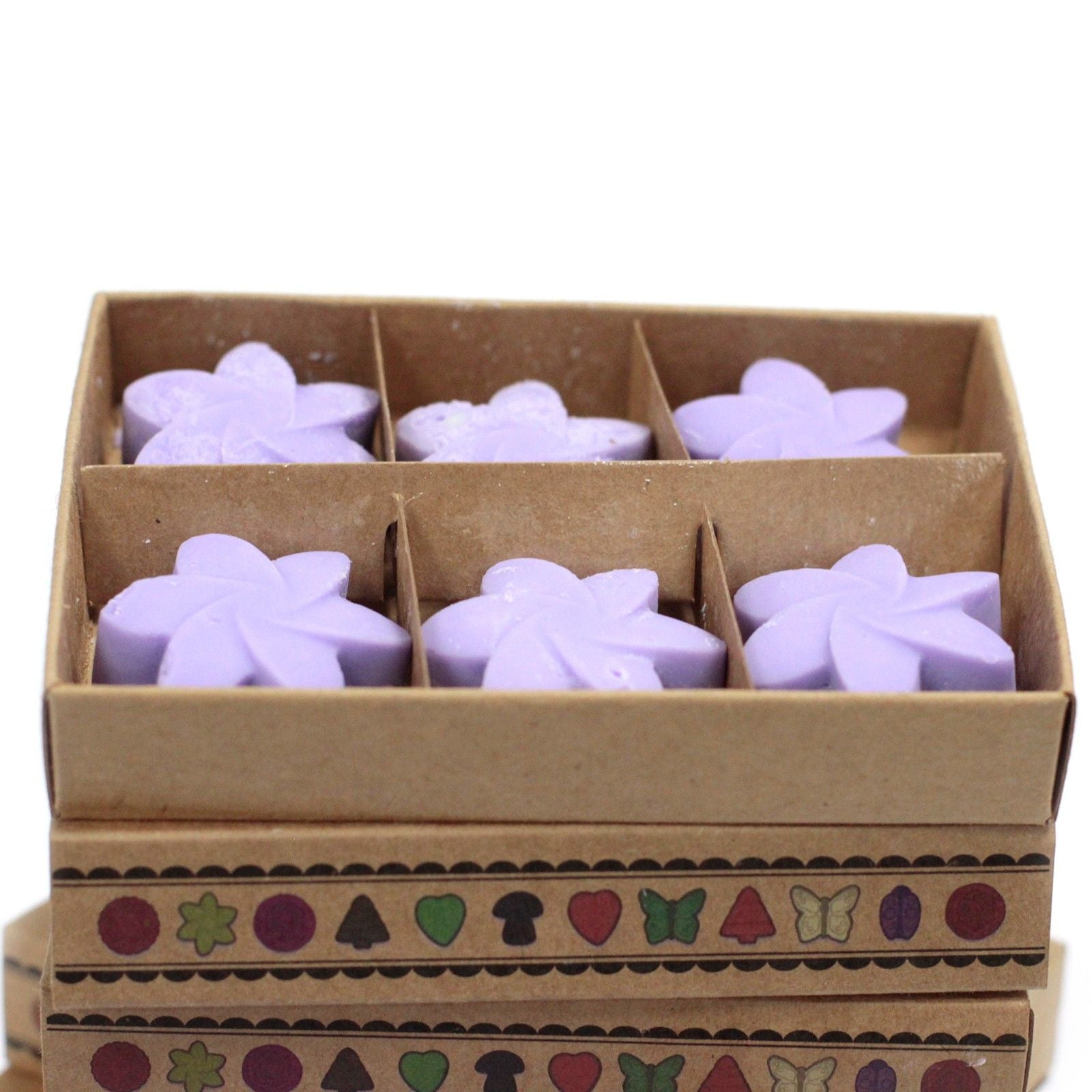 Box of purple star-shaped wax melts with decorative patterns on a white background